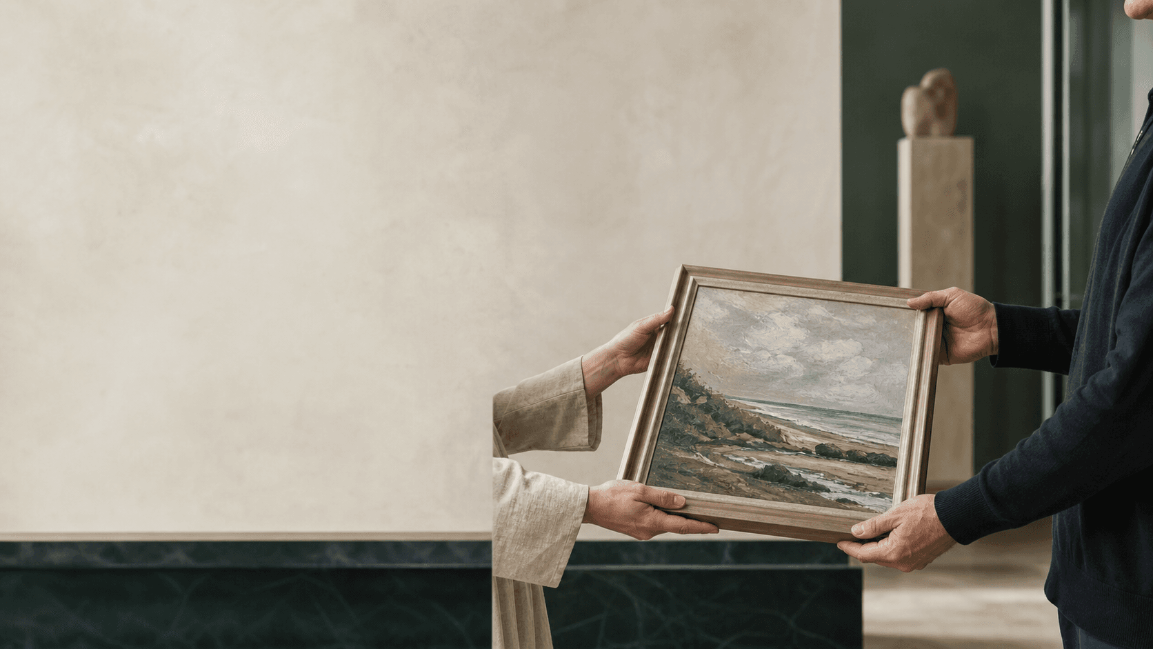 A framed original artwork being transferred between two people
